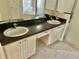 Bathroom featuring a double vanity, a glass shower, and white tile flooring at 2981 Winding Trl, Kissimmee, FL 34746