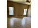 Bright bedroom featuring tiled floors, neutral walls, two large windows and a ceiling fan at 2981 Winding Trl, Kissimmee, FL 34746