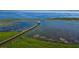 Aerial view of scenic boardwalk extending over the water with a gazebo and stunning views at 2981 Winding Trl, Kissimmee, FL 34746