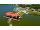 Aerial view of boat lift with access to the water, and a covered seating area on a sunny day at 2981 Winding Trl, Kissimmee, FL 34746