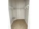 Empty closet with neutral tile floor, wire rack shelving, and white paint at 2981 Winding Trl, Kissimmee, FL 34746