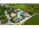 Aerial view of the community pool and clubhouse area with mature landscaping and surrounding green space at 2981 Winding Trl, Kissimmee, FL 34746