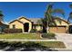 Charming single-story home featuring a tile roof, brick driveway, and well-maintained landscaping at 2981 Winding Trl, Kissimmee, FL 34746