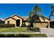 Charming single-story home featuring a tile roof, brick driveway, and well-maintained landscaping at 2981 Winding Trl, Kissimmee, FL 34746