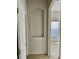 Open hallway with a built-in niche and views into a naturally lit room with white walls and tile floors at 2981 Winding Trl, Kissimmee, FL 34746