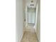 Hallway with tile floors, white walls, and access to multiple rooms at 2981 Winding Trl, Kissimmee, FL 34746