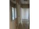 Hallway view features tan walls, tile floors and a mirror on the wall at 2981 Winding Trl, Kissimmee, FL 34746