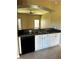 Kitchen featuring white cabinetry, black appliances, and granite countertops at 2981 Winding Trl, Kissimmee, FL 34746