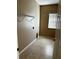 Practical laundry room features tile flooring, a window, and shelving ready for appliances at 2981 Winding Trl, Kissimmee, FL 34746