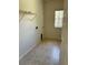 Laundry room with tile flooring, a small window, and shelving at 2981 Winding Trl, Kissimmee, FL 34746