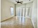 Room with neutral tile flooring, ceiling fan, and a glass sliding door to the exterior at 2981 Winding Trl, Kissimmee, FL 34746