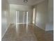 Spacious living area with neutral tile flooring and sliding glass doors to the exterior at 2981 Winding Trl, Kissimmee, FL 34746