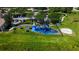 Aerial view of a community playground with swings, slides and picnic tables in green grass setting at 2981 Winding Trl, Kissimmee, FL 34746