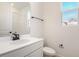 Modern bathroom featuring a white vanity, toilet and shower with natural light at 2985 Gavin Sky Dr, Kissimmee, FL 34744