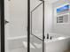 Bright bathroom featuring a soaking tub and separate shower with black frame at 2985 Gavin Sky Dr, Kissimmee, FL 34744