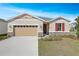 Charming single-Gathering home with a well-manicured lawn and stone accents at 2985 Gavin Sky Dr, Kissimmee, FL 34744