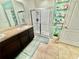 Well-lit bathroom with a granite countertop vanity, and a glass-enclosed shower at 3082 Royal Tern Dr, Winter Haven, FL 33881