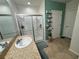 Well-lit bathroom featuring a glass-enclosed shower, a vanity sink, and modern fixtures at 3082 Royal Tern Dr, Winter Haven, FL 33881