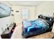 This bedroom offers a modern aesthetic, featuring a striking blue and black comforter and mounted TV at 3082 Royal Tern Dr, Winter Haven, FL 33881