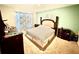 Cozy bedroom with green walls features a plush bed and warm carpet flooring at 3082 Royal Tern Dr, Winter Haven, FL 33881