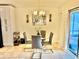 A stylish dining area features a modern glass table, four chairs, and a contemporary chandelier at 3082 Royal Tern Dr, Winter Haven, FL 33881