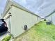 The exterior wall of this home has a hose neatly coiled and a well-maintained lawn at 3082 Royal Tern Dr, Winter Haven, FL 33881