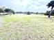 The extensive field with manicured grass and mature trees offers ample space for outdoor recreation at 3082 Royal Tern Dr, Winter Haven, FL 33881