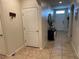 Hallway with neutral paint, tile flooring, a storage bench, and a front door at 3082 Royal Tern Dr, Winter Haven, FL 33881