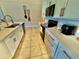 An efficient kitchen space features white cabinets, black appliances, and stylish gold hardware at 3082 Royal Tern Dr, Winter Haven, FL 33881