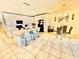 Bright kitchen boasts white cabinetry, modern appliances, island with seating, and tiled floors at 3082 Royal Tern Dr, Winter Haven, FL 33881
