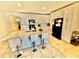 A bright kitchen features an island with seating, white cabinetry, and modern appliances, ready for cooking at 3082 Royal Tern Dr, Winter Haven, FL 33881