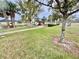 Community playground is set amidst a lush lawn with mature trees, offering a safe recreational space at 3082 Royal Tern Dr, Winter Haven, FL 33881