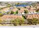 An aerial view of multiple townhomes in a community near a small lake with fountains at 3102 Ashland N Ln # 3152, Kissimmee, FL 34741