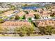 An aerial view of multiple townhomes in a community near a small lake with fountains at 3102 Ashland N Ln # 3152, Kissimmee, FL 34741