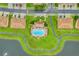 Aerial shot of a resort-style pool area surrounded by townhomes and connected by walking paths at 3102 Ashland N Ln # 3152, Kissimmee, FL 34741