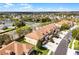 Aerial shot showing the townhome community, roofs, and a nearby street at 3102 Ashland N Ln # 3152, Kissimmee, FL 34741