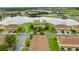 Aerial view of a townhome community surrounding a pond and featuring a community pool at 3102 Ashland N Ln # 3152, Kissimmee, FL 34741