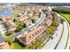 Aerial view of a townhome community close to a lake with fountain and tree-lined street at 3102 Ashland N Ln # 3152, Kissimmee, FL 34741