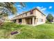 View of the backyard with a grassy lawn and covered patio area at 3102 Ashland N Ln # 3152, Kissimmee, FL 34741