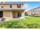 Backyard with sliding glass doors onto the patio, leading to a grassy area at 3102 Ashland N Ln # 3152, Kissimmee, FL 34741