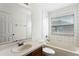 Bathroom with tub and shower, vanity with large mirror, and tiled walls at 3102 Ashland N Ln # 3152, Kissimmee, FL 34741
