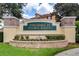 Elegant entrance sign for Townhomes at Flora Ridge with manicured landscaping and brick accents at 3102 Ashland N Ln # 3152, Kissimmee, FL 34741