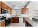 Kitchen featuring stainless steel appliances, wood cabinets, tile floors and granite countertops at 3102 Ashland N Ln # 3152, Kissimmee, FL 34741
