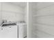 Laundry room featuring white washer and dryer and wire shelving at 3102 Ashland N Ln # 3152, Kissimmee, FL 34741