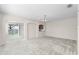 Large, open living room featuring neutral walls and carpet and large sliding door at 3102 Ashland N Ln # 3152, Kissimmee, FL 34741