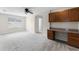 Upstairs loft area with built-in desk, storage cabinets and neutral-colored walls at 3102 Ashland N Ln # 3152, Kissimmee, FL 34741