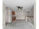 Upstairs loft area with built-in desk, storage cabinets and neutral-colored walls at 3102 Ashland N Ln # 3152, Kissimmee, FL 34741