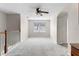 Upstairs loft area featuring carpet floors, a window and a view of the home's interior at 3102 Ashland N Ln # 3152, Kissimmee, FL 34741