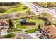 Aerial view of a neighborhood playground with a blue playset and swing set surrounded by green grass at 3102 Ashland N Ln # 3152, Kissimmee, FL 34741