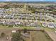 Expansive neighborhood showcasing numerous homes, tree-lined streets, and community amenities, creating an inviting atmosphere at 3142 Hill Point St, Minneola, FL 34715